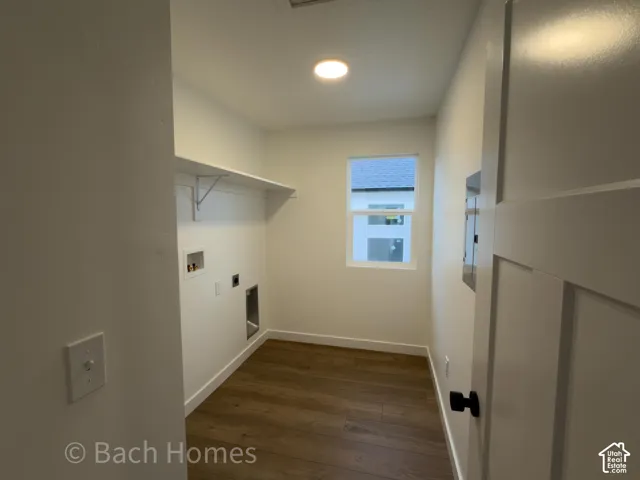 Laundry room featuring wood-finish flooring, a single-hung window, recessed lighting, and a built-in wall shelf