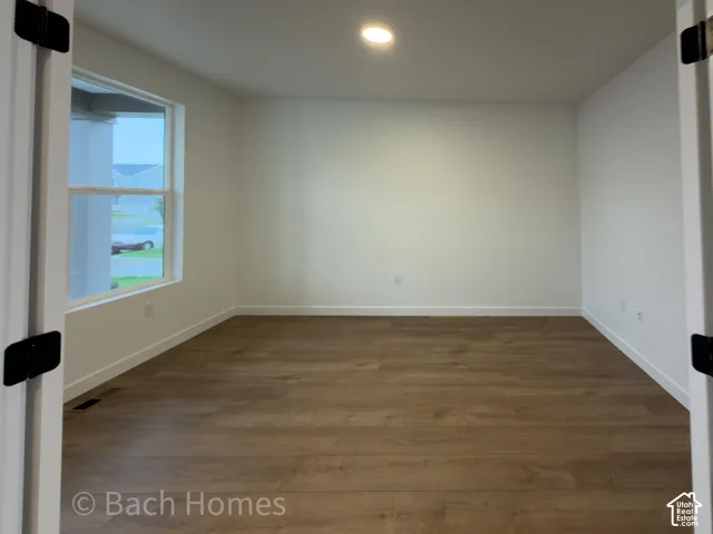 Interior space featuring wood-finish flooring, double-door entryway, and recessed lighting