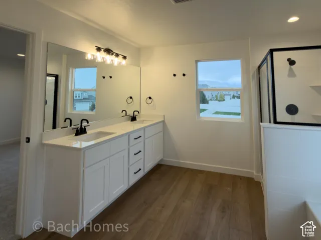 Double vanity with white cabinetry, light-toned countertop, and dual rectangular undermount sinks