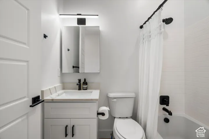 Bathroom featuring a white subway tile surround, matte black shower fixtures, and a curved shower rod