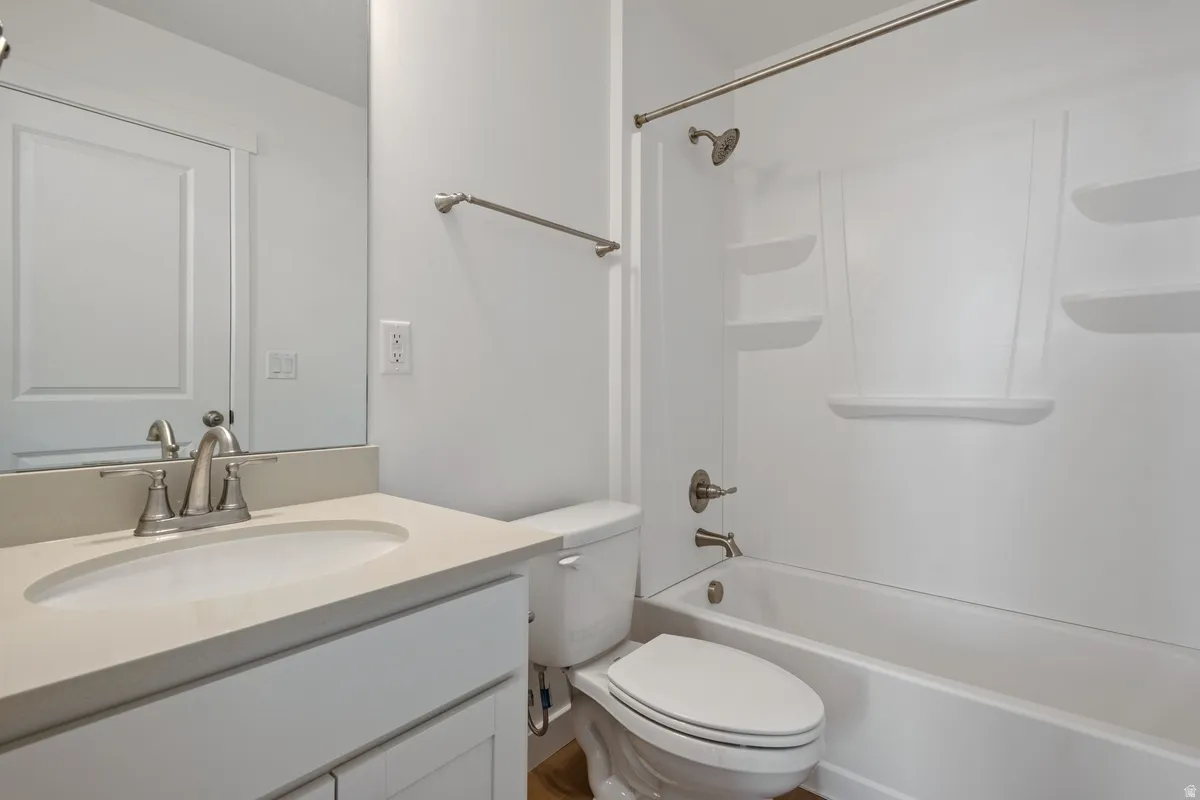 Bathroom featuring a white vanity with a light countertop, a built-in sink, and a brushed nickel faucet