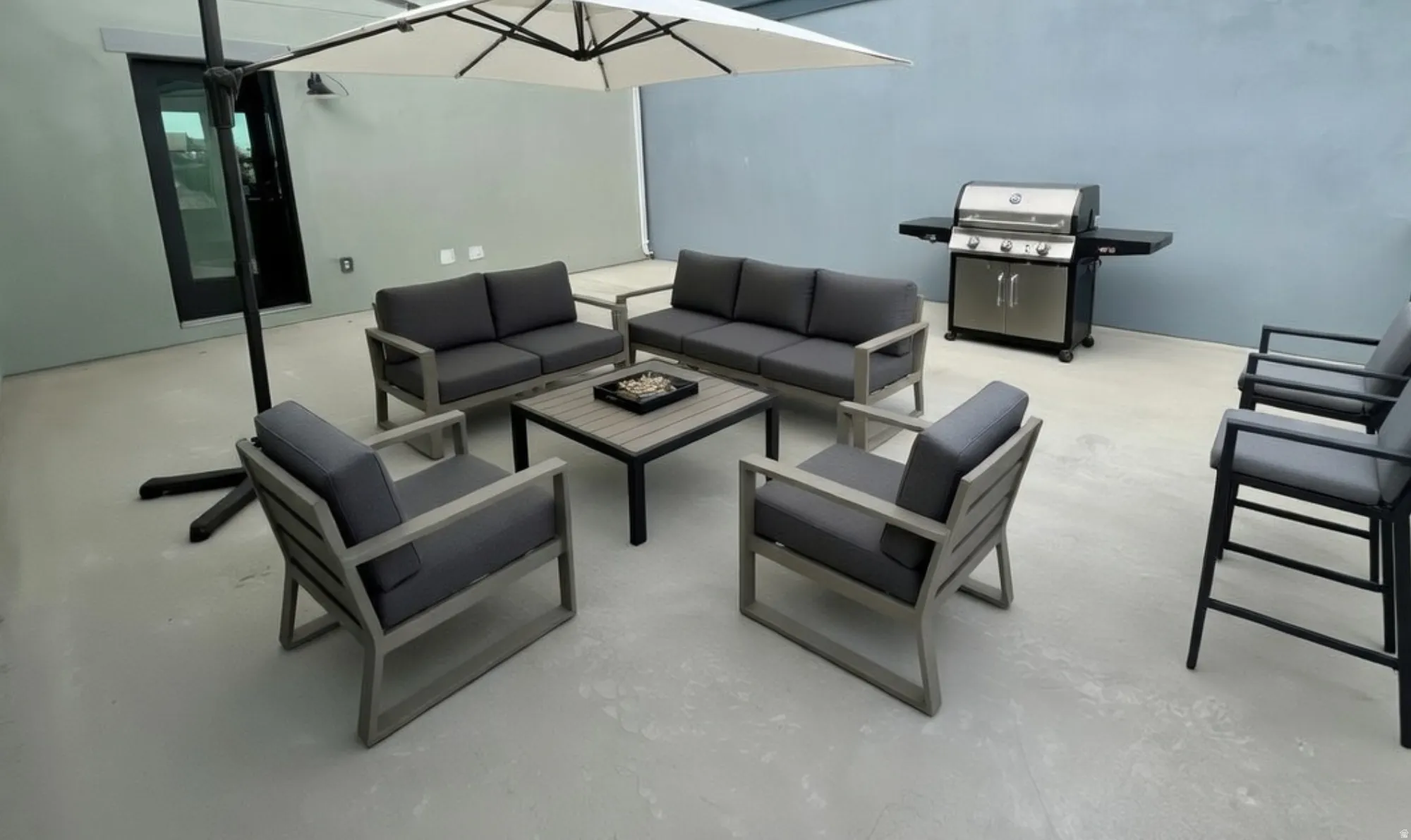 Expansive outdoor patio area featuring a light-toned concrete surface