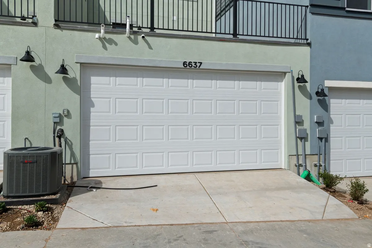 Attached garage featuring a panel-style door