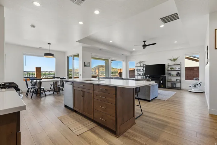 Open-concept living space featuring wood-finish flooring, recessed lighting, and a modern ceiling fan