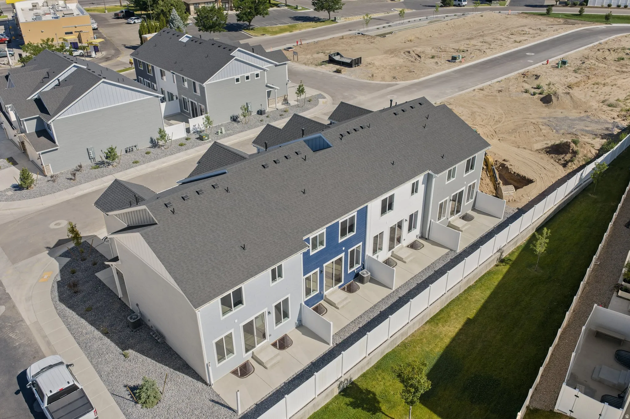 Contemporary townhome development featuring multi-tone facades and private rear patios