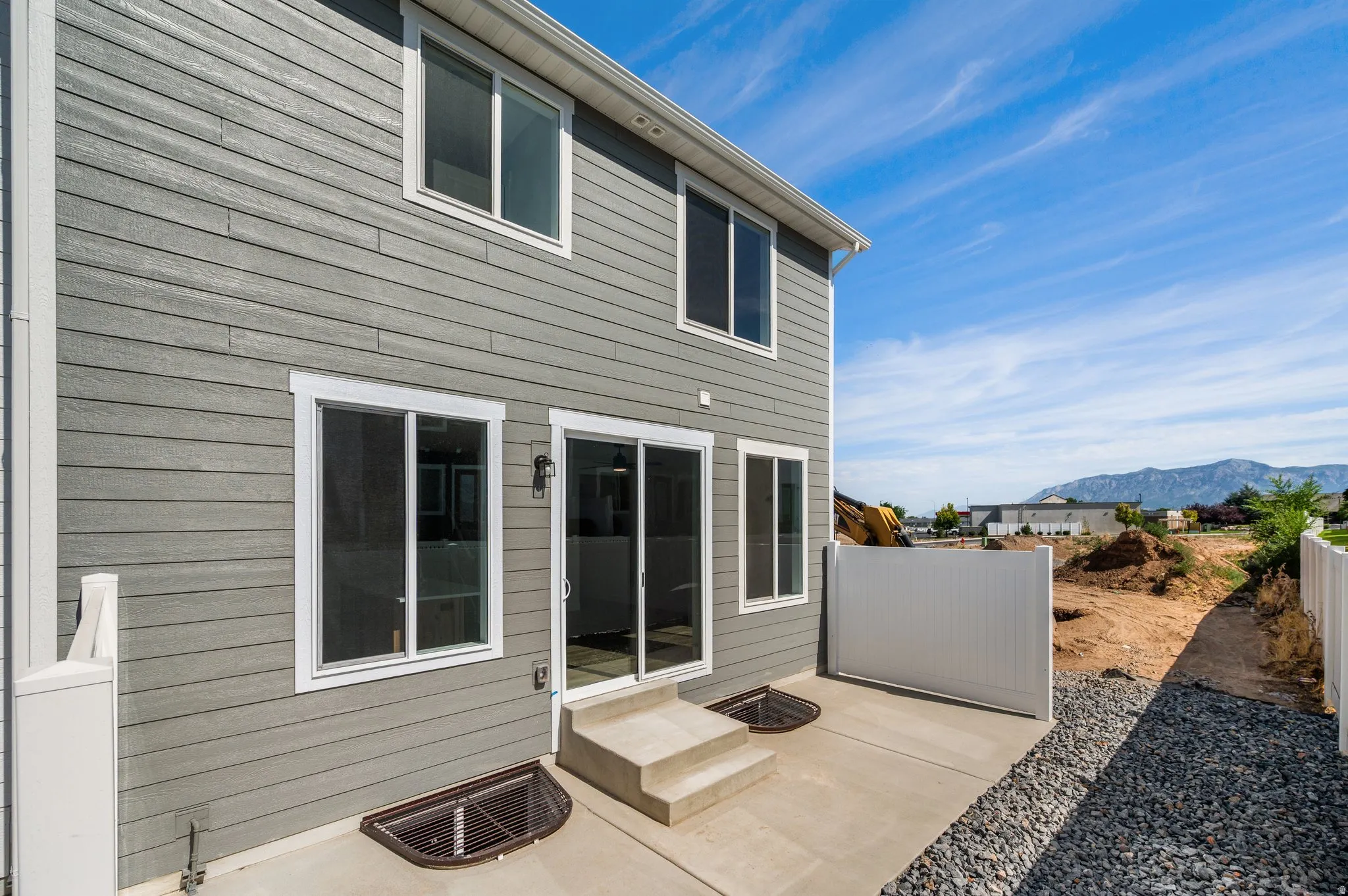 Rear exterior with gray horizontal siding and white trim