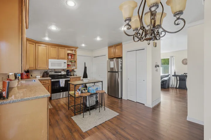 Kitchen featuring wood-finish flooring, recessed lighting, and a decorative chandelier