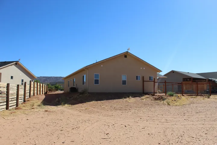Stucco exterior with a pitched roofline