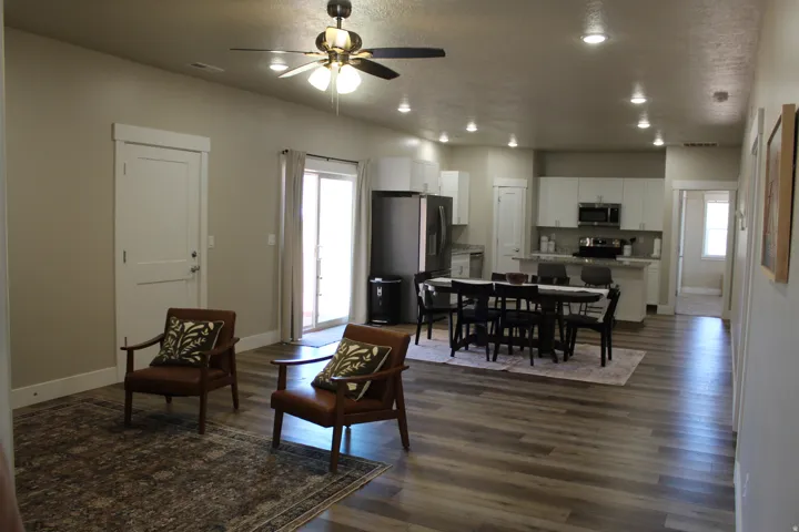 Open-concept living space featuring wood-finish flooring, recessed lighting, and a modern ceiling fan