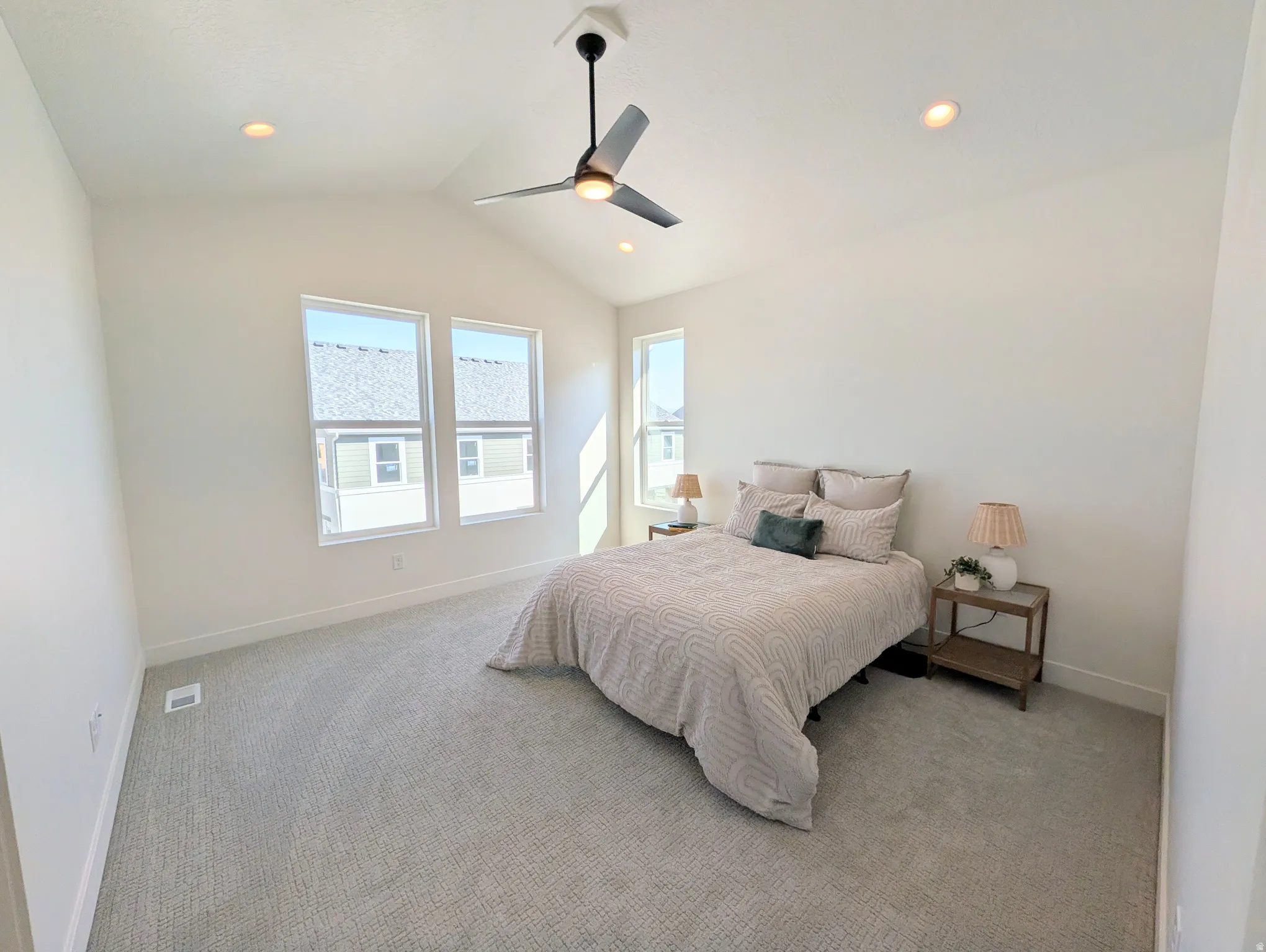Primary bedroom with Vaulted ceilings with recessed lighting and a ceiling fan