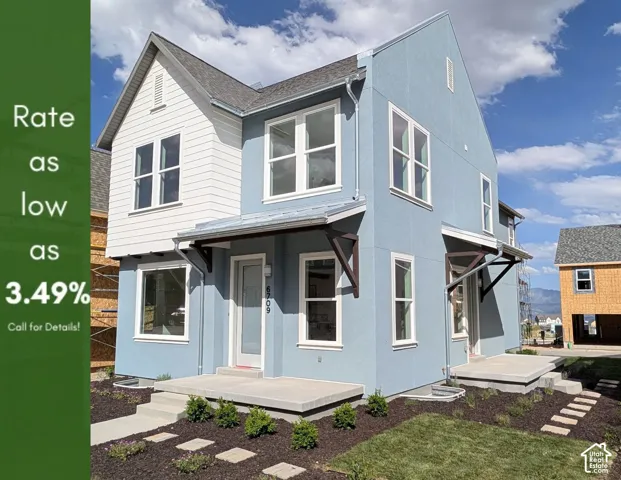 Two-story residence featuring light blue stucco and white siding