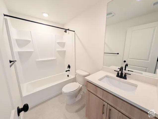 White bathtub with integrated shelving and matte black fixtures