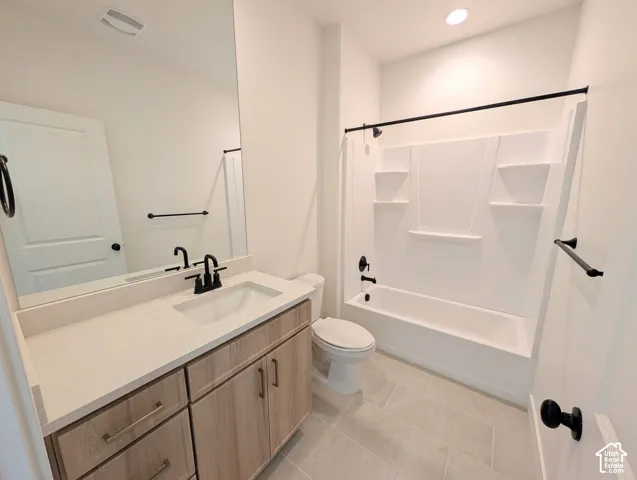 Light wood-finish vanity with a light-toned countertop and integrated sink