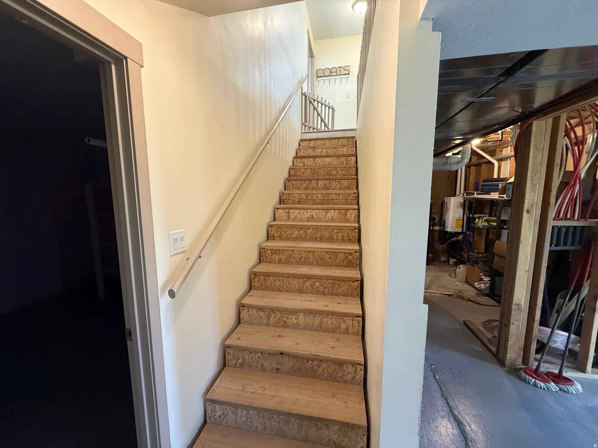Unfinished wood stairwell providing access to multiple levels