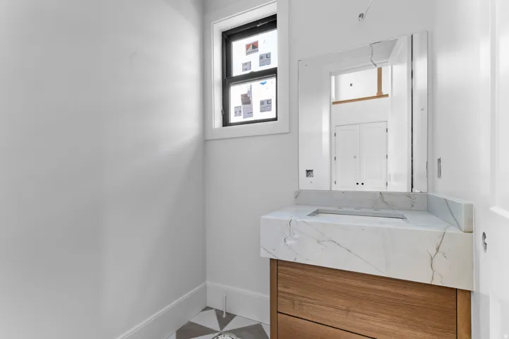 Floating wood-finish vanity with an integrated rectangular sink and quartz countertop