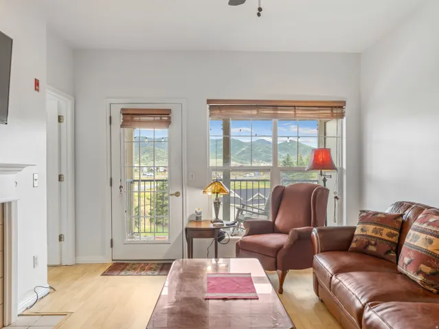 Bright living space featuring light wood-finish flooring and white walls