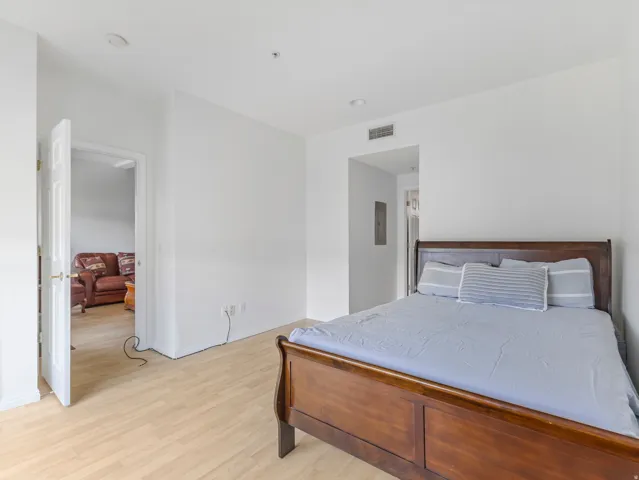Bright interior space featuring light wood-finish flooring and white walls