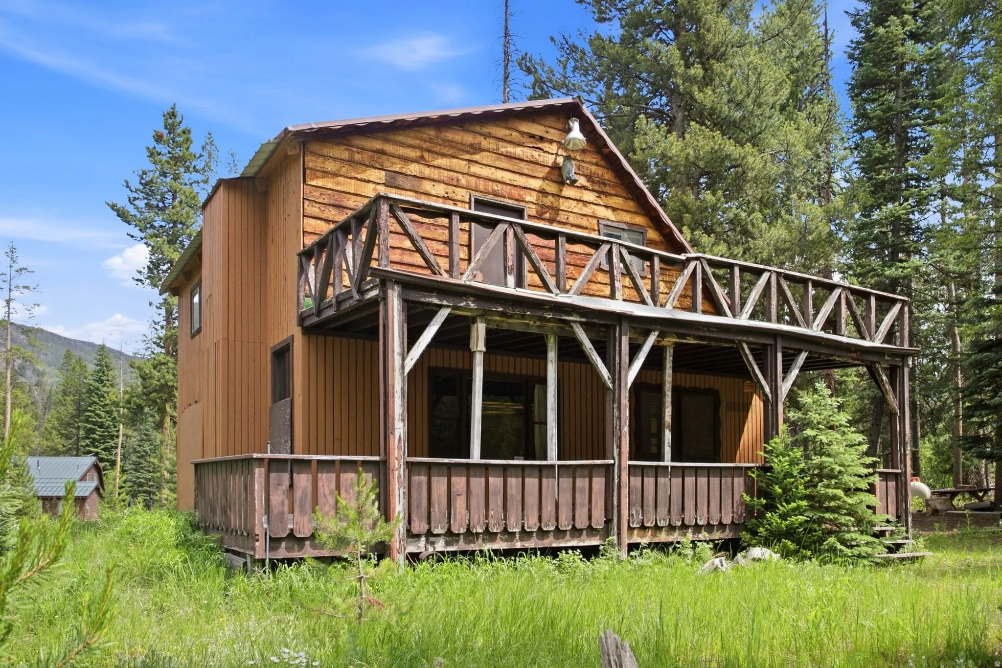 Wood-clad exterior with a two-story design featuring a covered porch and an upper-level balcony