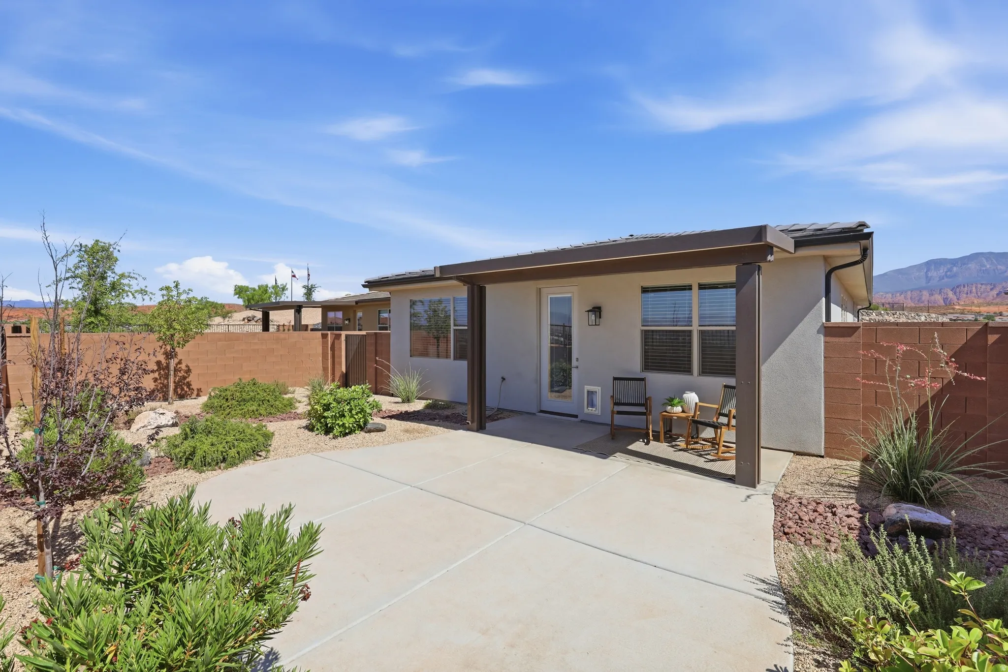 Expansive concrete patio area with a covered outdoor living space