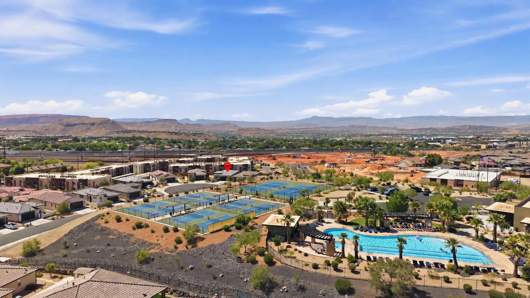 Community amenities featuring a large outdoor swimming pool, multiple tennis courts, and landscaped common areas