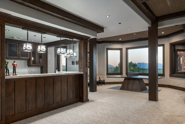 Spacious interior featuring a built-in wet bar with dark wood cabinetry and a light-toned countertop
