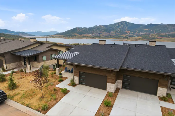 Modern residences featuring multi-toned siding, stone accents, and contemporary garage doors