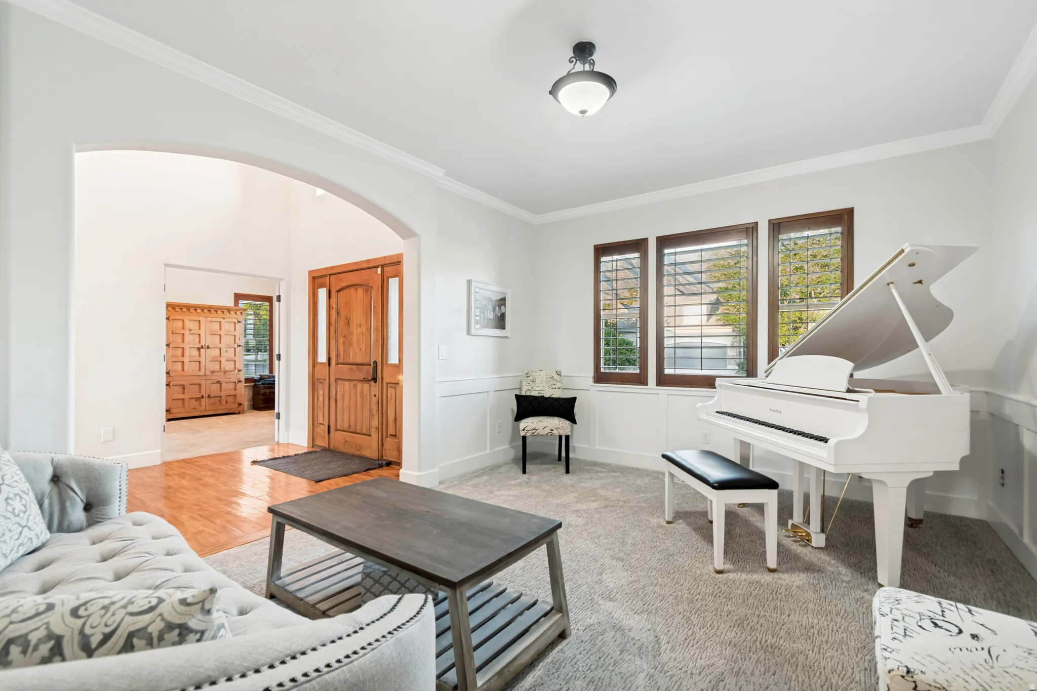 Formal living room featuring an arched entryway, crown molding, and incredible mountain views.