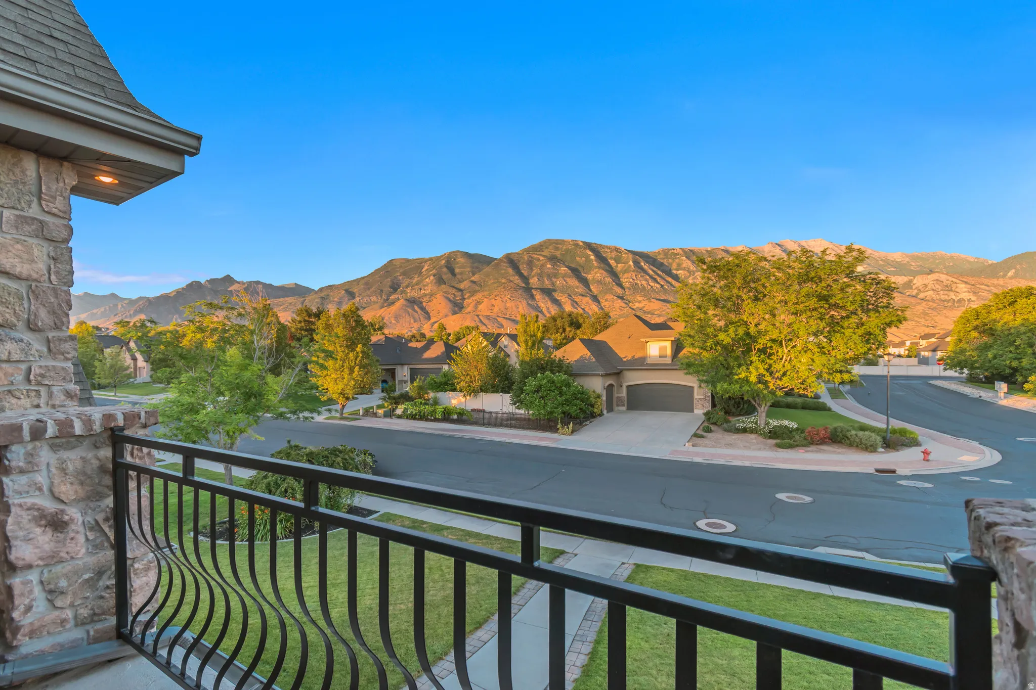 Balcony featuring an ornate wrought iron railing and stone column with incredible mountain scenery to enjoy.