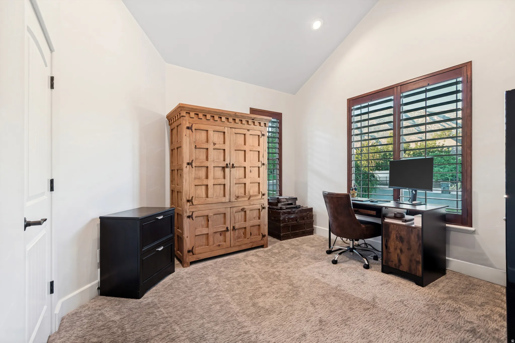Carpeted office with vaulted ceilings, closet space, and incredible mountain views.
