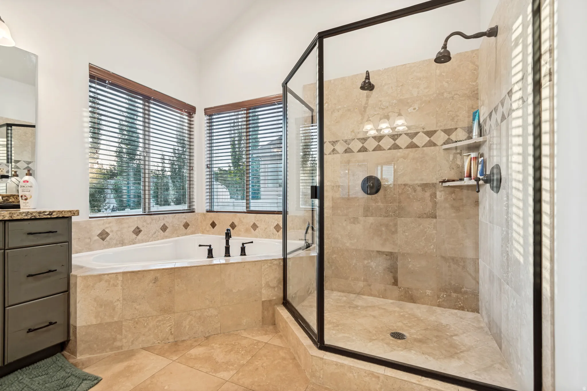 Large jetted tub and separate walk-in shower with tile surrounds.