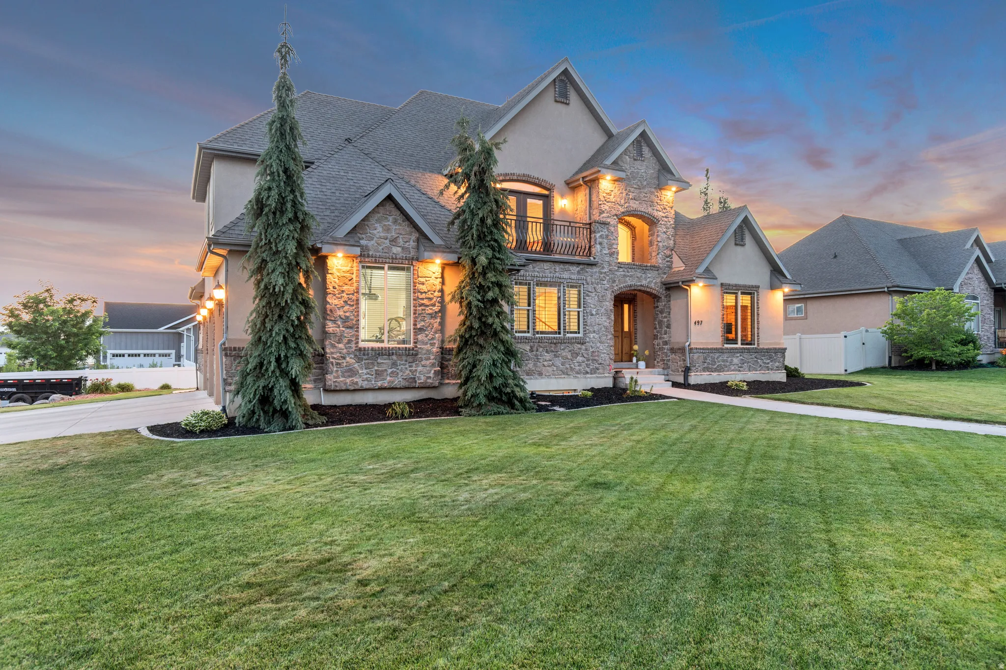 Stone and stucco exterior featuring multiple gables and a prominent entry.