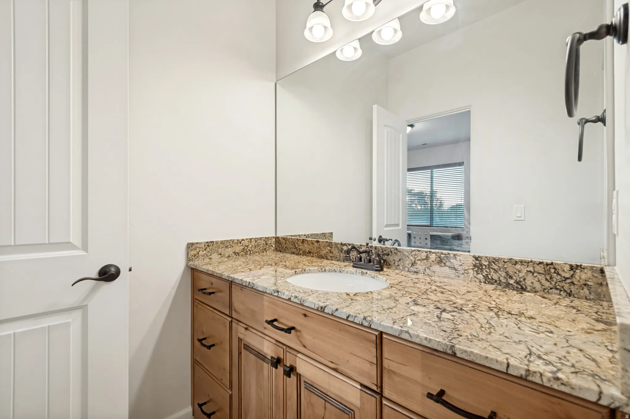Upstairs bedroom #3 private vanity and sink with granite countertop.