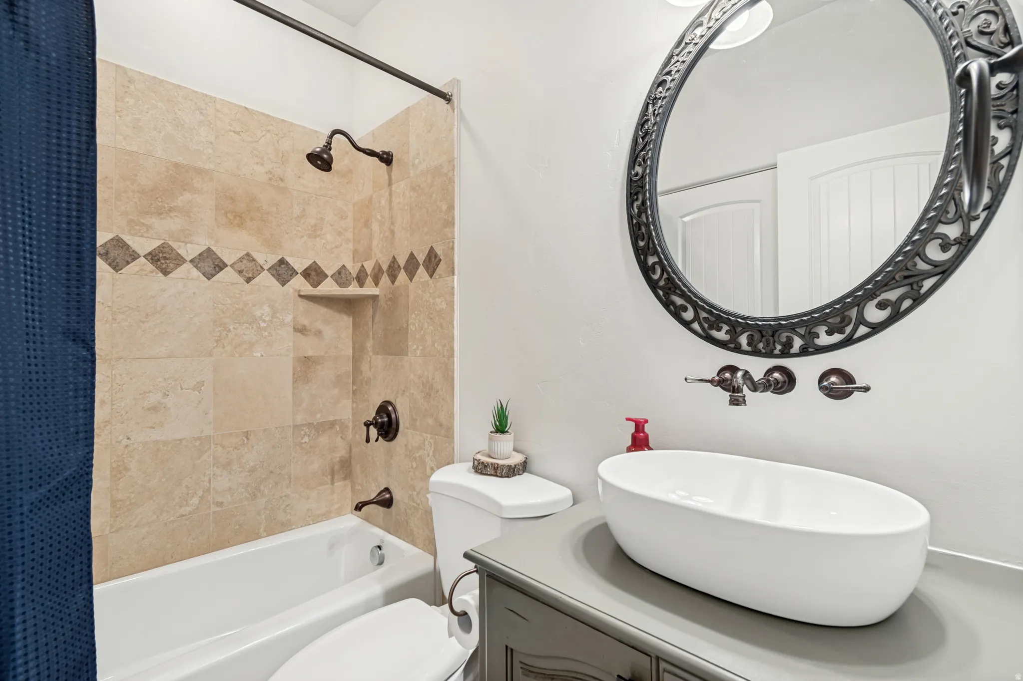 Main-floor guest full bathroom, with dual access from entryway and office.