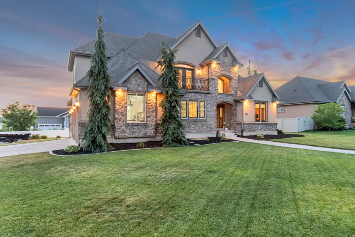 Stone and stucco exterior featuring multiple gables and a prominent entry.