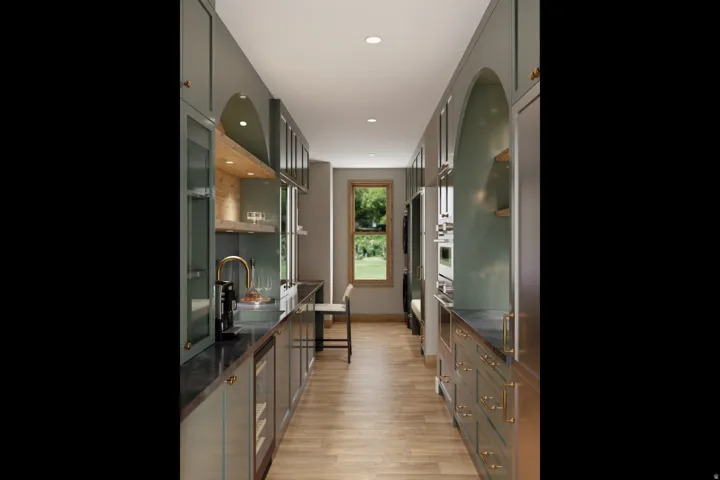 Galley kitchen featuring wood-finish flooring, custom cabinetry, built-in appliances, a beverage refrigerator, and a window with natural light