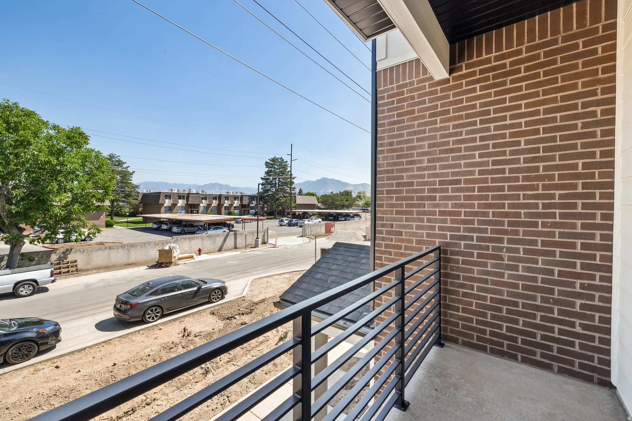 Private balcony with concrete flooring and contemporary black metal railings
