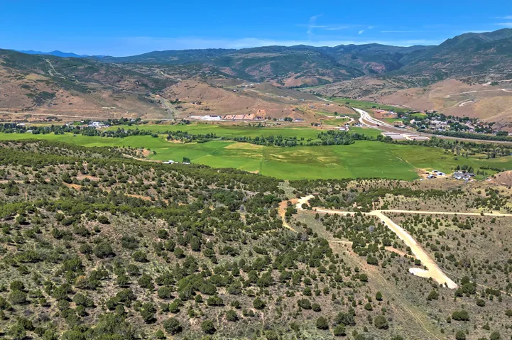 Expansive land parcel featuring natural shrubbery and visible dirt roads