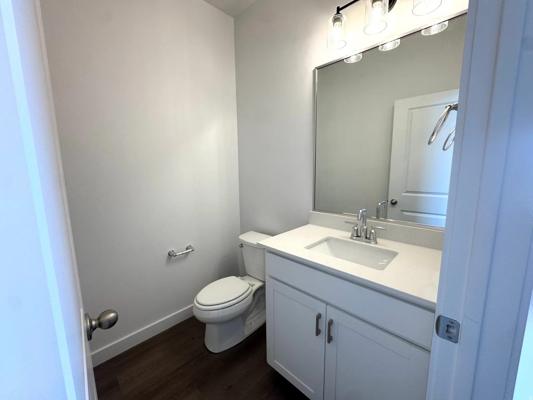 Vanity featuring a rectangular sink, a white countertop, and a chrome faucet