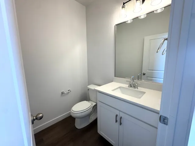 Vanity featuring a rectangular sink, a white countertop, and a chrome faucet