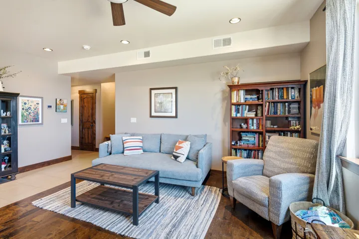 Bright, open living area featuring a ceiling fan, recessed lighting, and hardwood flooring throughout