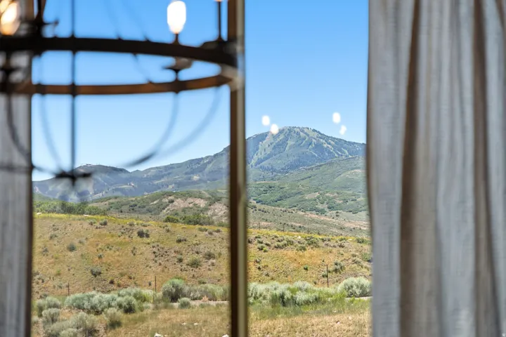 Expansive mountainous terrain with varied green foliage and clear skies