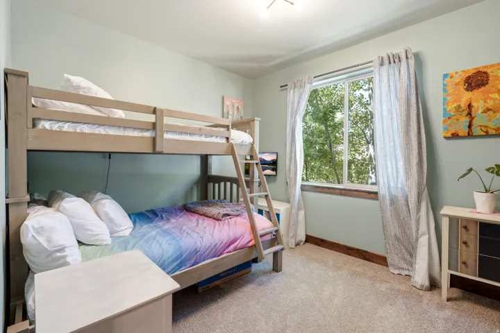 Carpeted flooring, single window with natural light, light-toned walls, wood-finish trim