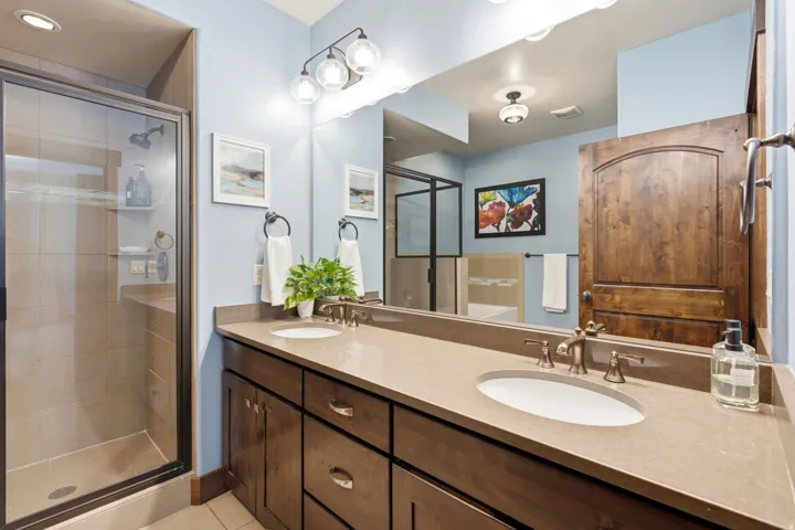 Double vanity with integrated sinks, brushed nickel fixtures, and ample counter space