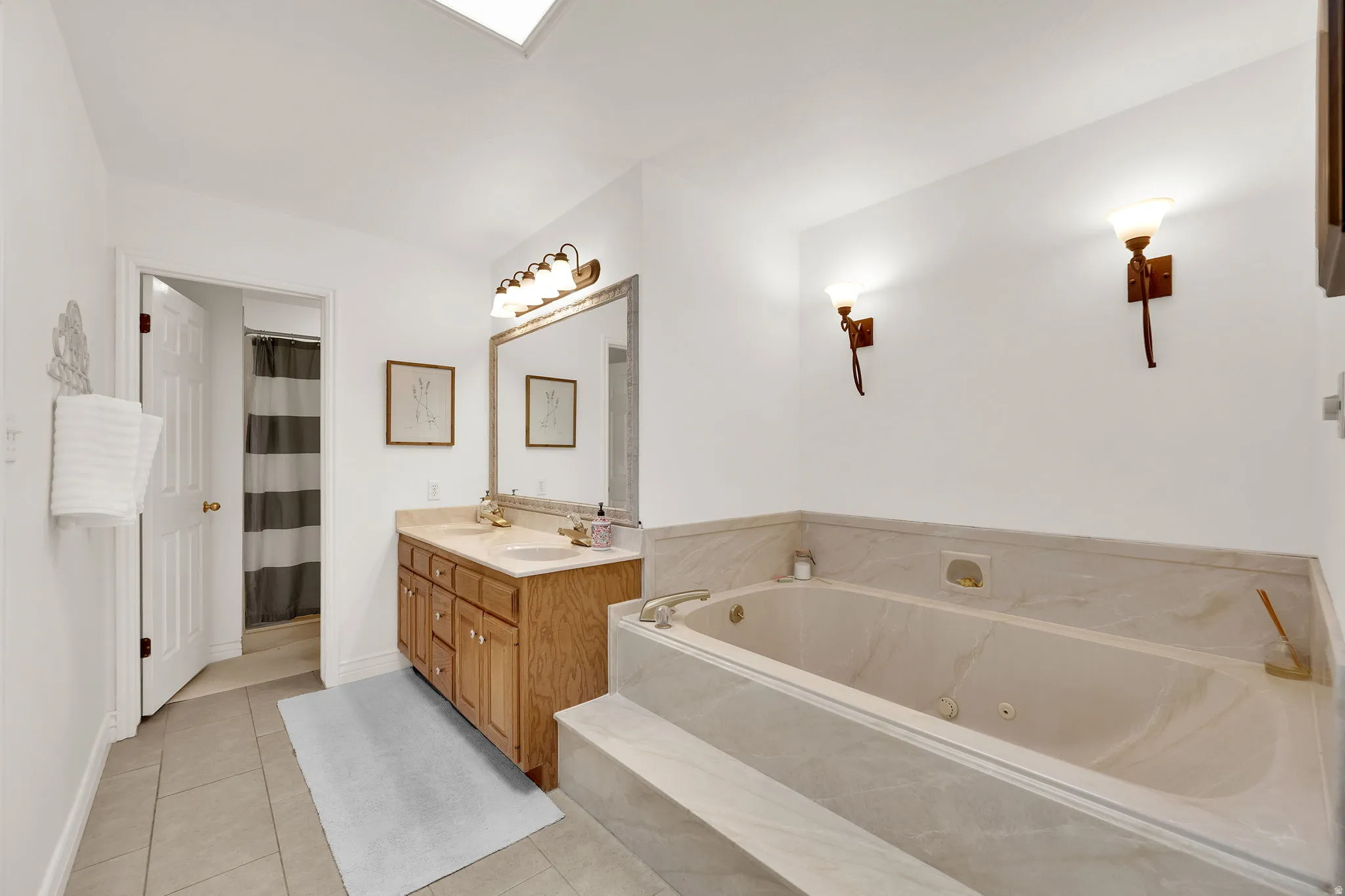 Primary suite bathroom with extra-large jetted tub and double vanity