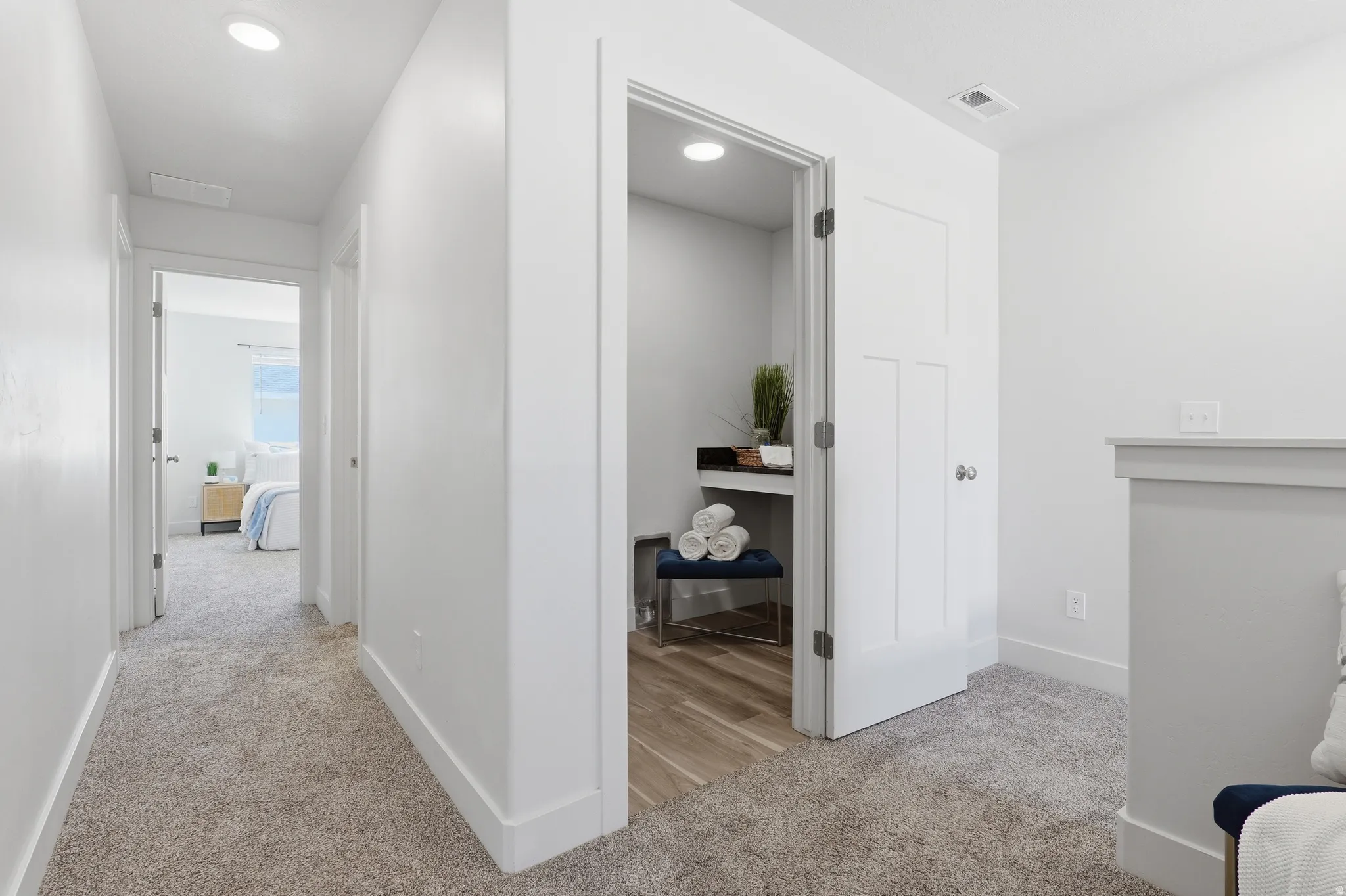 Upper-level hallway featuring recessed lighting, a neutral carpet, and white trim