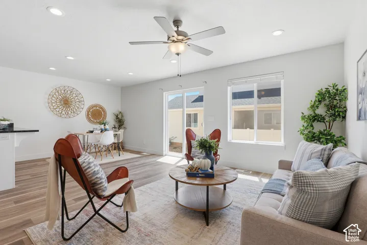 Open-concept living area featuring wood-finish flooring, recessed lighting, and a ceiling fan