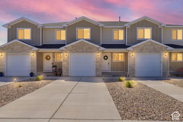 Modern townhome-style residences featuring light-colored siding and stone facade accents