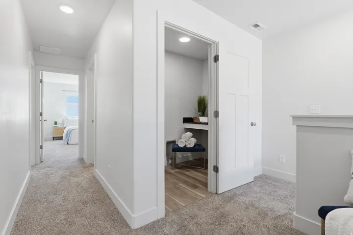 Upper-level hallway featuring recessed lighting, a neutral carpet, and white trim