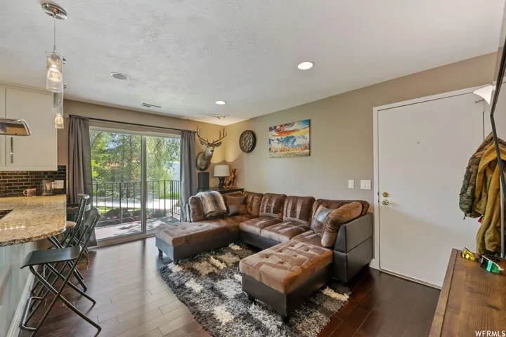 Open-concept living area with dark wood-finish flooring