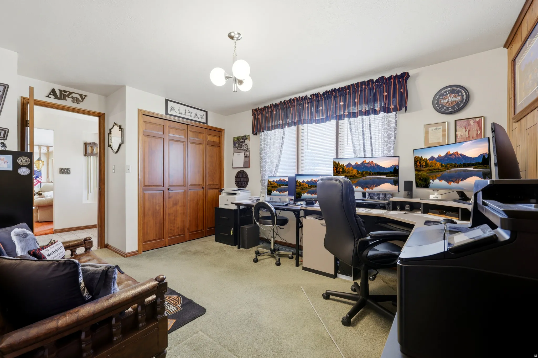 Spacious interior room featuring light green carpeting and a wall of wood-finish bi-fold closet doors